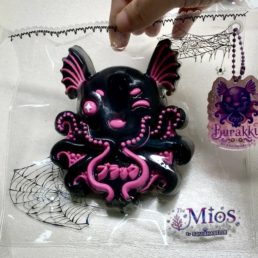 Burakku squishy in clear Halloween-themed The Mios packaging with acrylic portrait and name tag